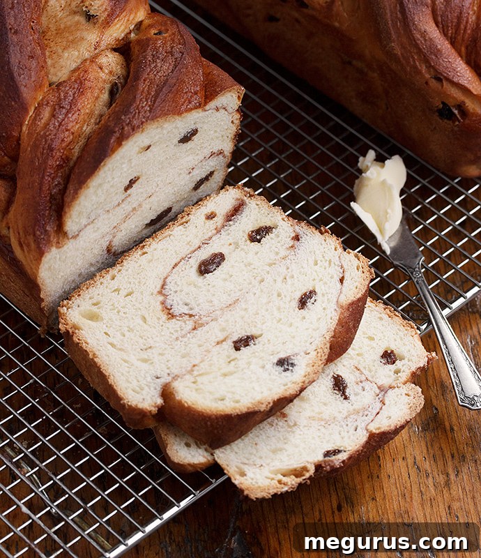 Close-up of a slice of Cinnamon Raisin Swirl Bread, showing the distinct layers of cinnamon sugar and plump raisins.