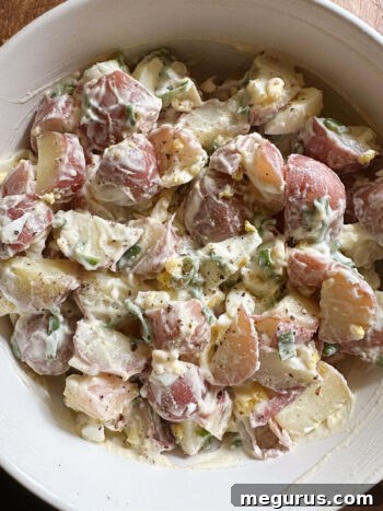 Stirring the potato egg salad until all ingredients are well combined