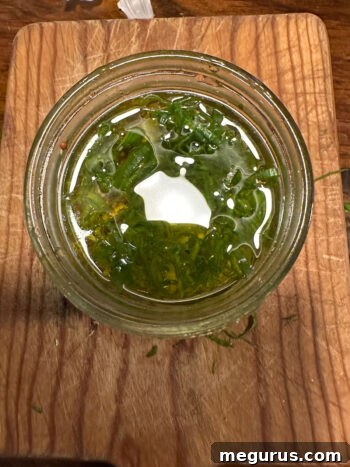 Ingredients for the vinaigrette dressing in a small jar, ready to be shaken.