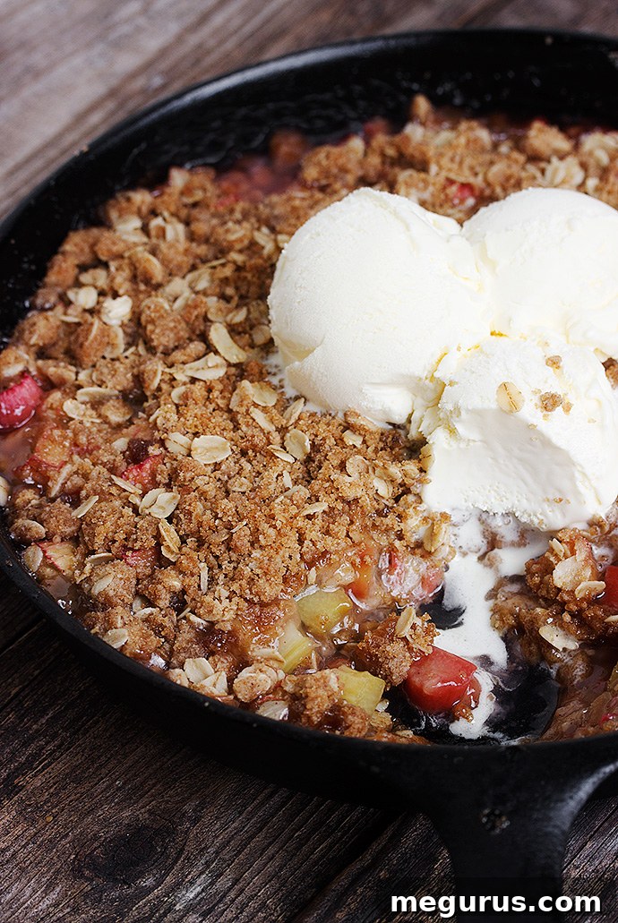 Close-up of Skillet Rhubarb Crisp with a golden crumb topping and juicy, sweet rhubarb filling, ready to be served warm.