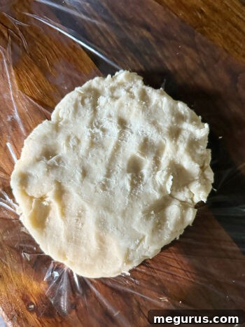 Patting the dough into a 1-inch thick round shape