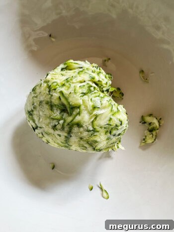 Squeezed zucchini after excess liquid has been removed, significantly drier.