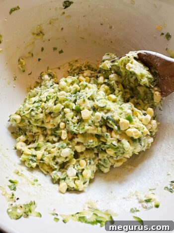 The fully mixed zucchini corn fritter batter, ready for frying.