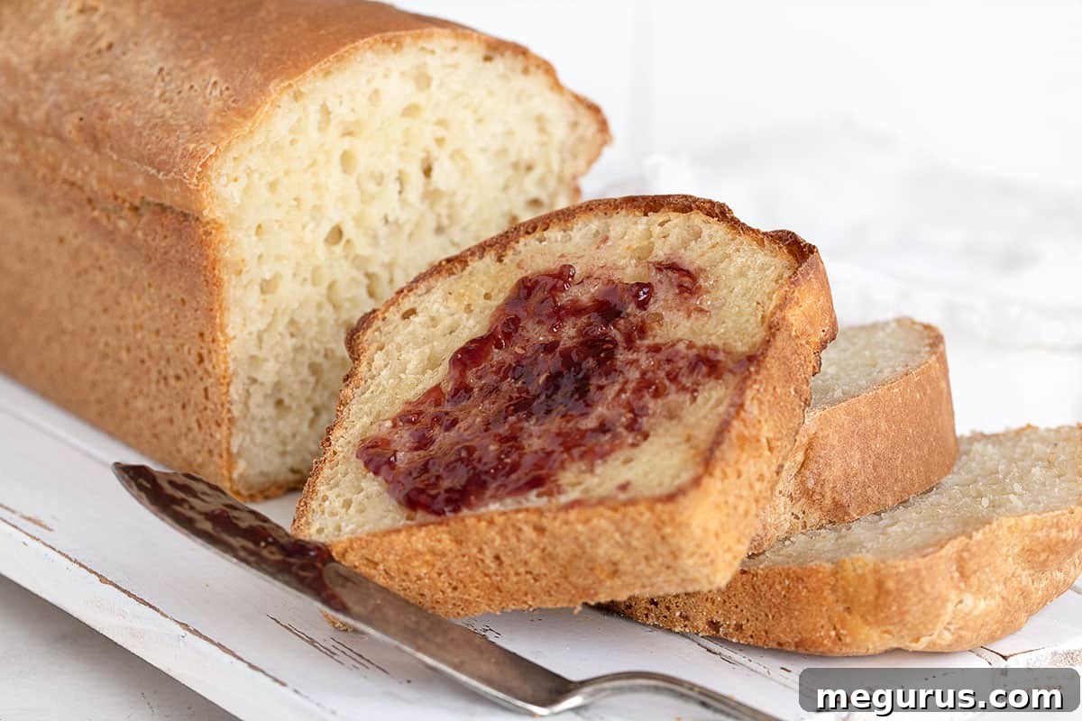 Sliced English Muffin Bread with butter and jam, showing its characteristic texture.