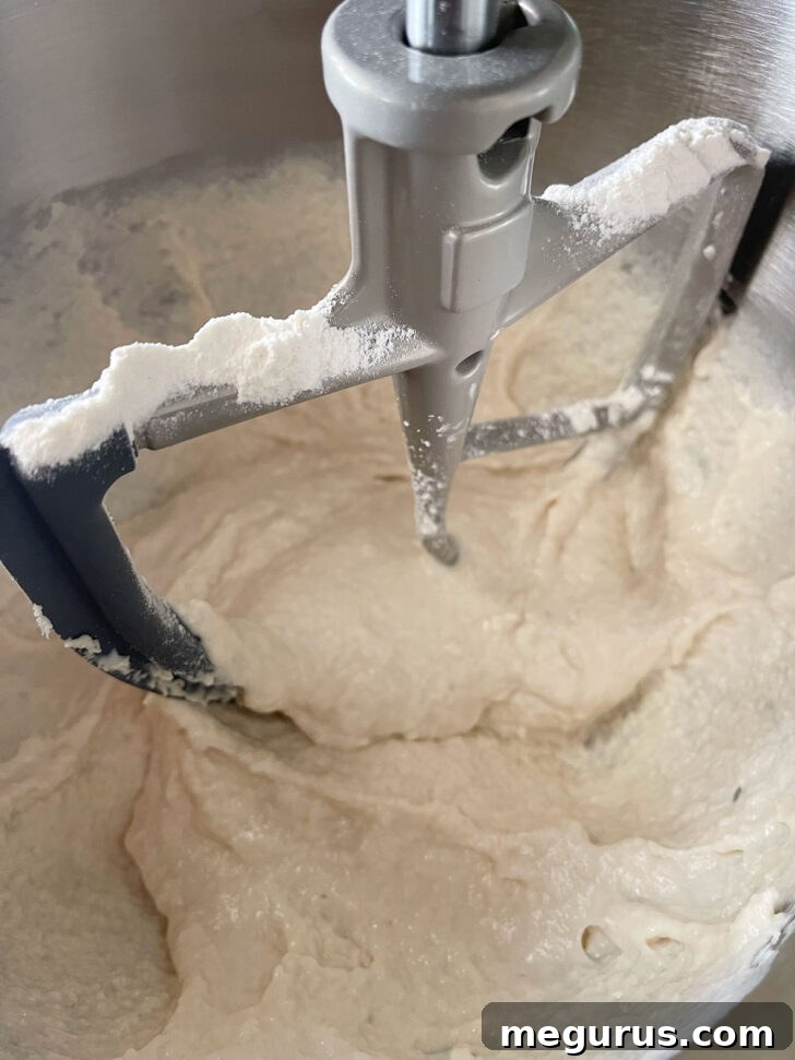 English muffin bread dough after initial mixing, showing a thick batter consistency.