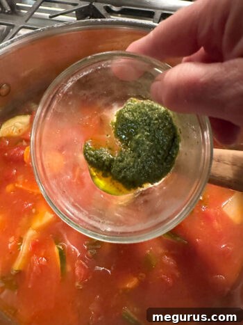 finishing soup with basil pesto