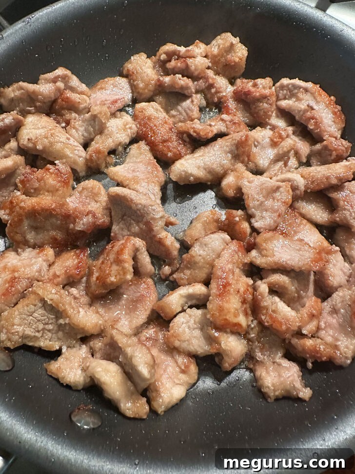 Golden brown pork pieces after frying in a skillet