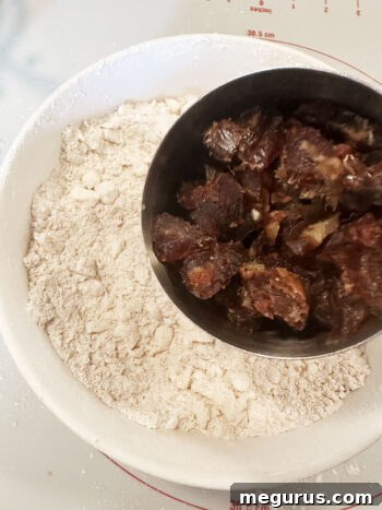adding dates to flour butter mixture