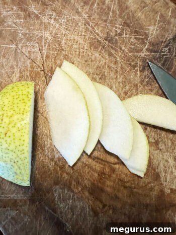 slicing pear on cutting board