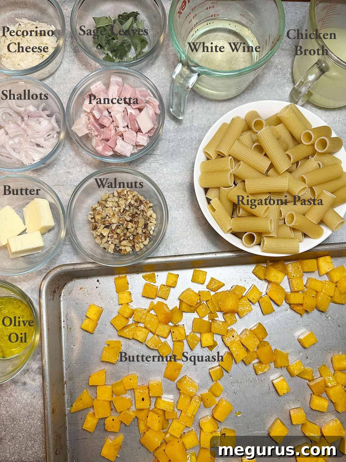 Various fresh ingredients for roasted butternut squash pasta including cubed squash, pancetta, sage, and pasta.