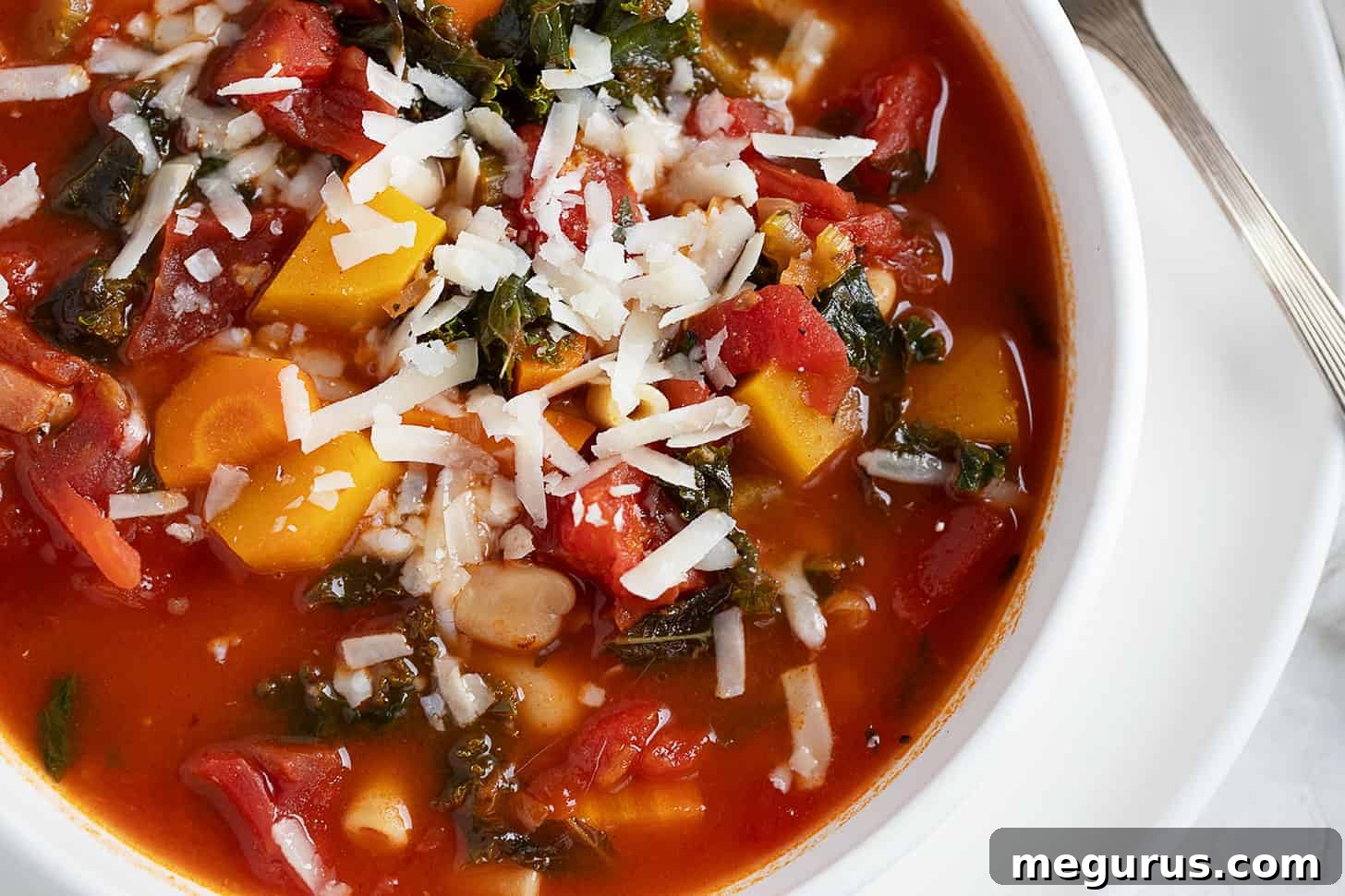 A bowl of hearty Fall Minestrone Soup, garnished and ready to be enjoyed.
