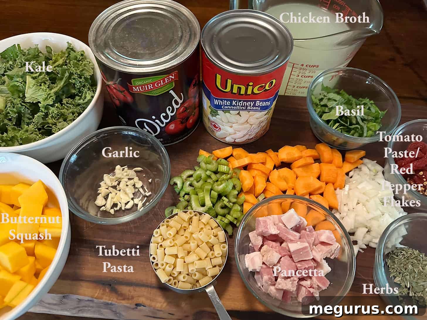 Various Fall minestrone ingredients laid out on a kitchen counter.
