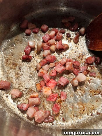 Browning the pancetta in a large soup pot.