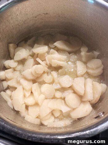 Tender, cooked parsnips in the saucepan after simmering.