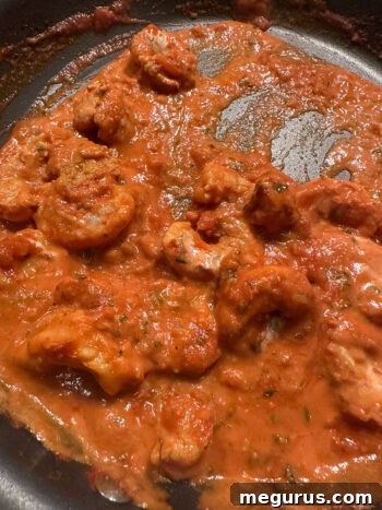 The finished Shrimp Tikka Masala simmering gently in a skillet, ready to be served.