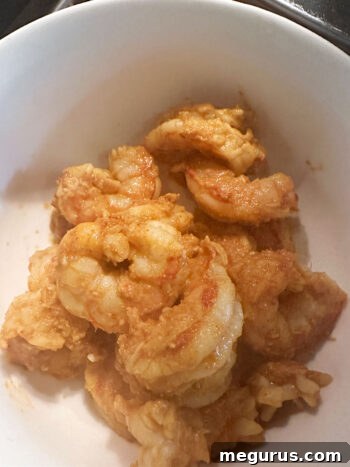 Cooked shrimp removed from the skillet and placed into a separate bowl.