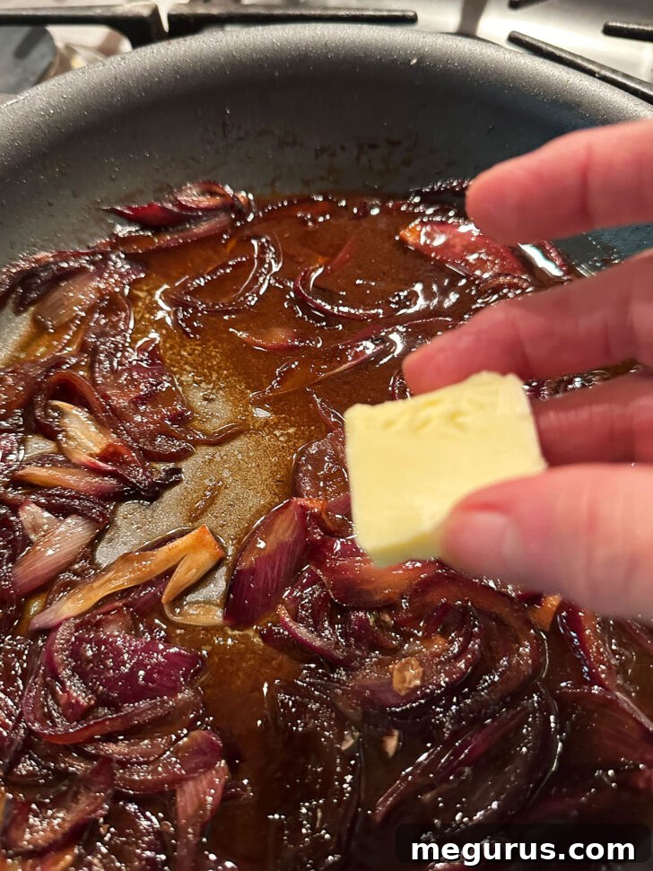 Finishing the balsamic onions in the skillet with a final touch of butter.