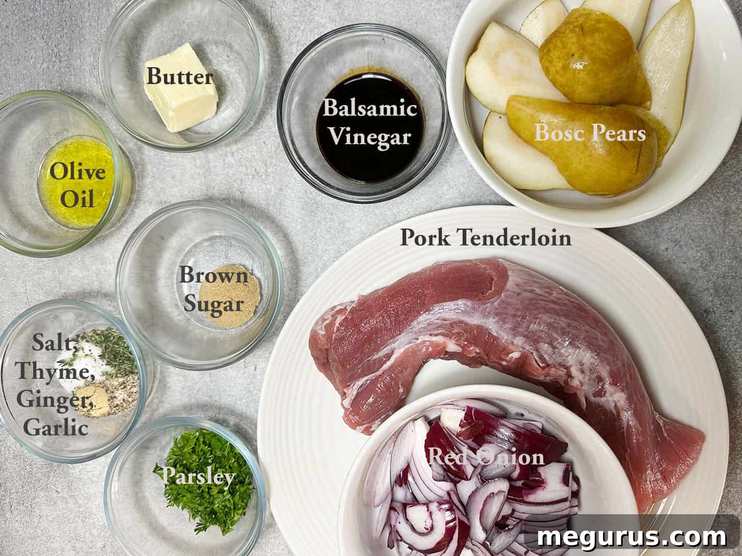 Collection of fresh ingredients for preparing pork tenderloin with pears and balsamic onions.