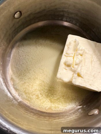 Butter melting in a small saucepan over medium heat.