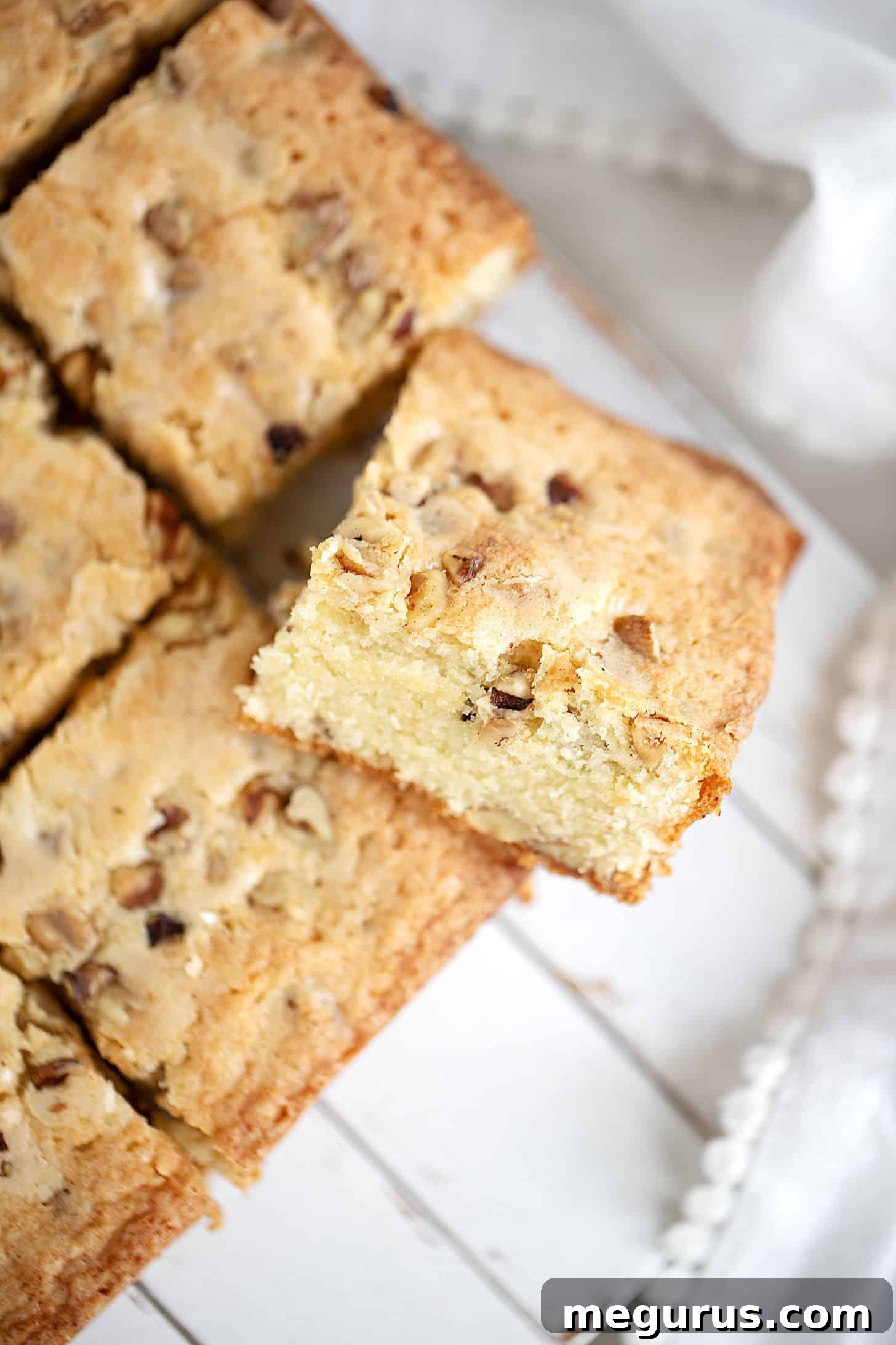 Beautifully arranged maple walnut blondies slices on a serving board.