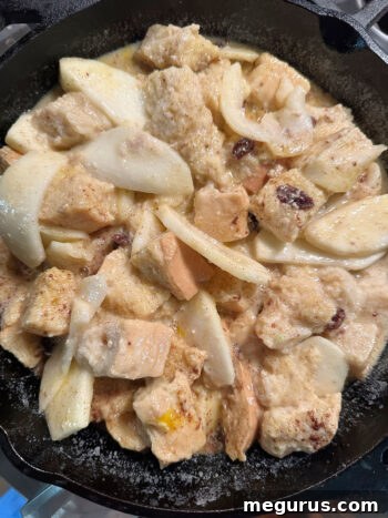 Spoon bread mixture into cast iron skillet before baking for a golden, bubbly finish