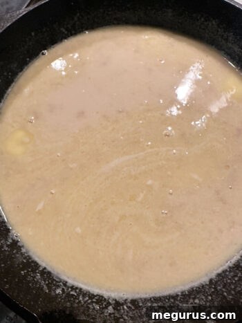 Warm milk mixture after heating, with butter melted and sugar dissolved