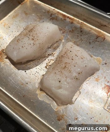 Cooked white fish fillets ready to be served with the curry sauce