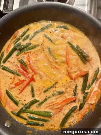 Curry sauce simmering gently in the skillet