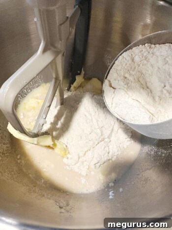 Initial amount of flour being added to the mixing bowl to start the dough.