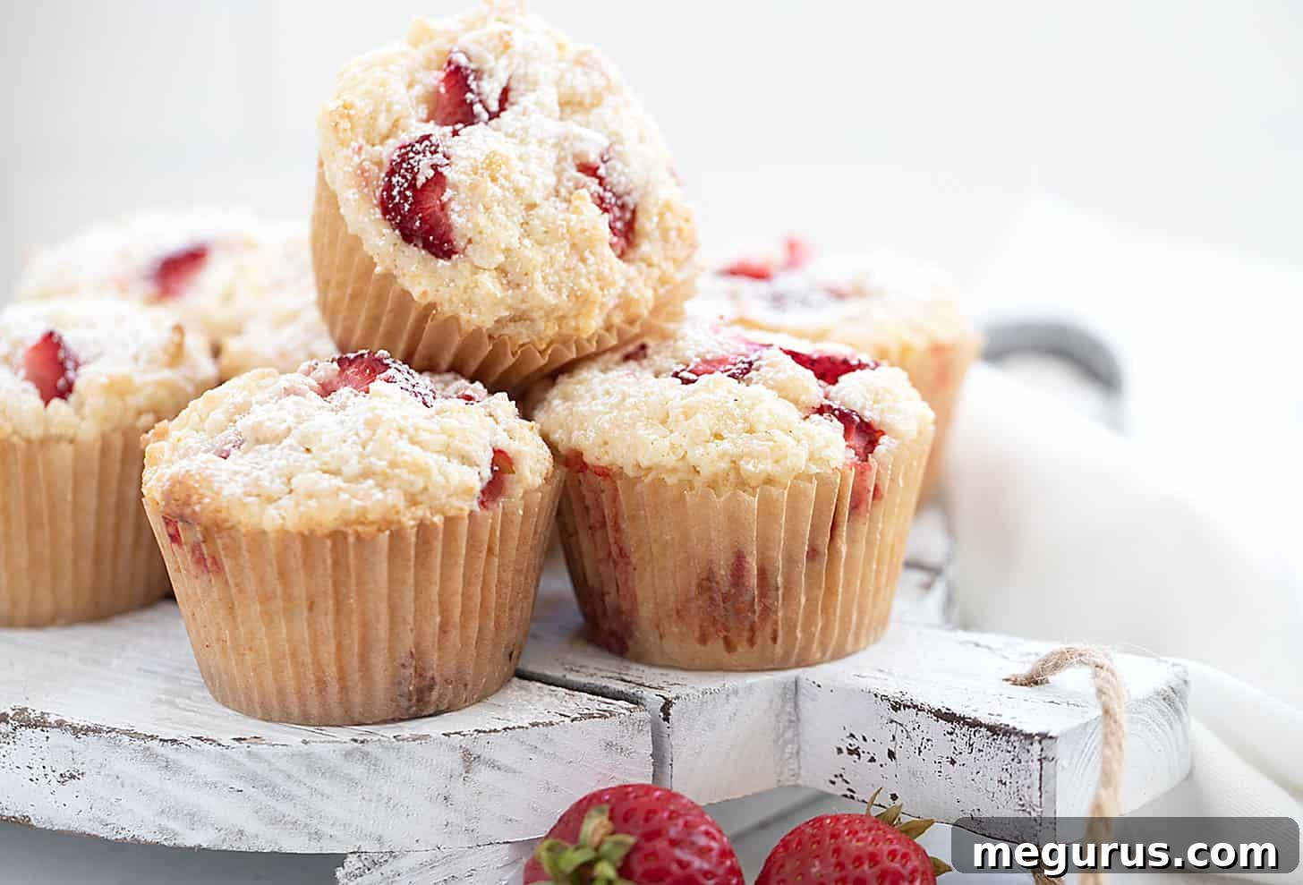 Delicious strawberry shortcake muffins on a rustic serving board, ready to be enjoyed