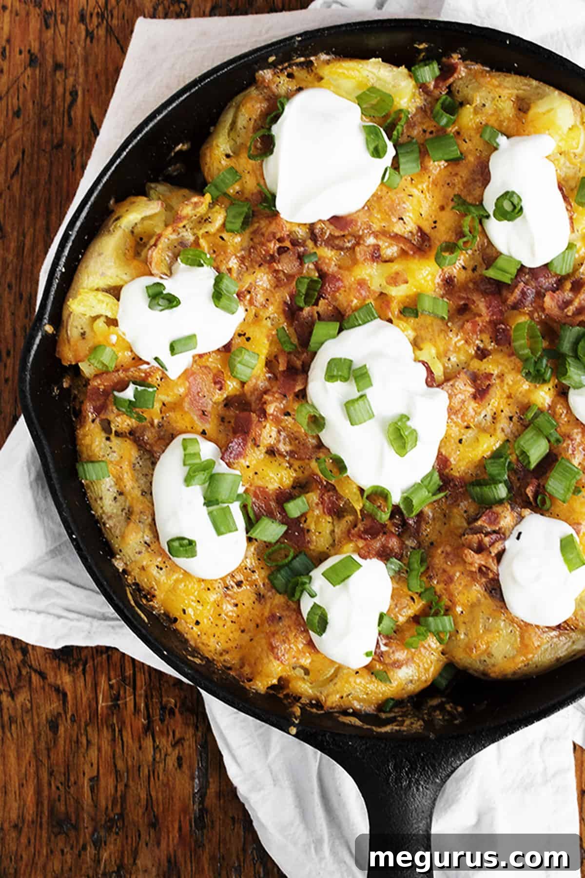 Close-up of golden brown Loaded Smashed Potato Skillet