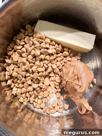Peanut butter, butterscotch chips, and butter combined in a saucepan, ready to melt.