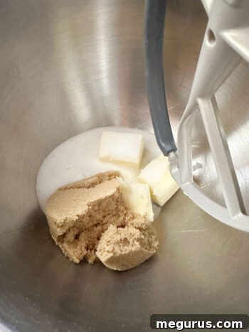 Creaming room temperature butter and sugar in a mixer to start the cookie dough.
