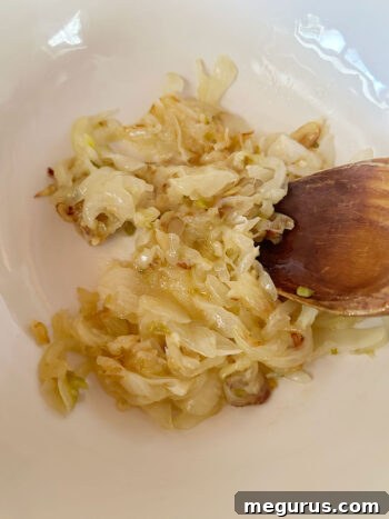 Perfectly caramelized onions resting in a bowl, ready to be mixed with the other dip ingredients.