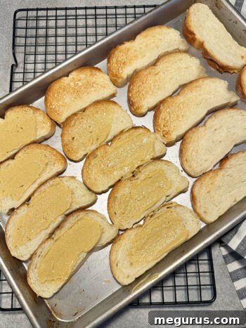 lightly toasted bread slices on a baking tray