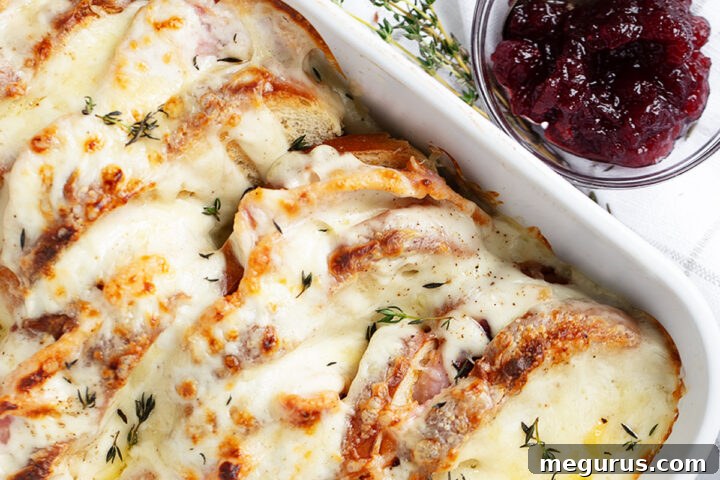 Croque Monsieur casserole in baking dish with cranberry sauce on the side