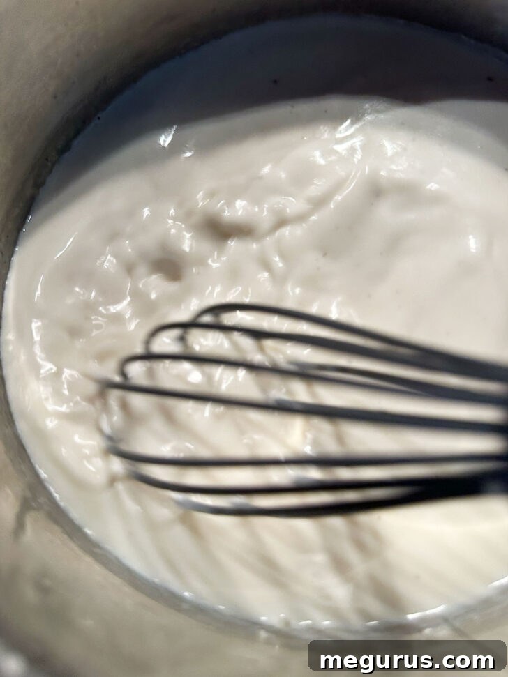whisking milk in saucepan to prevent lumps