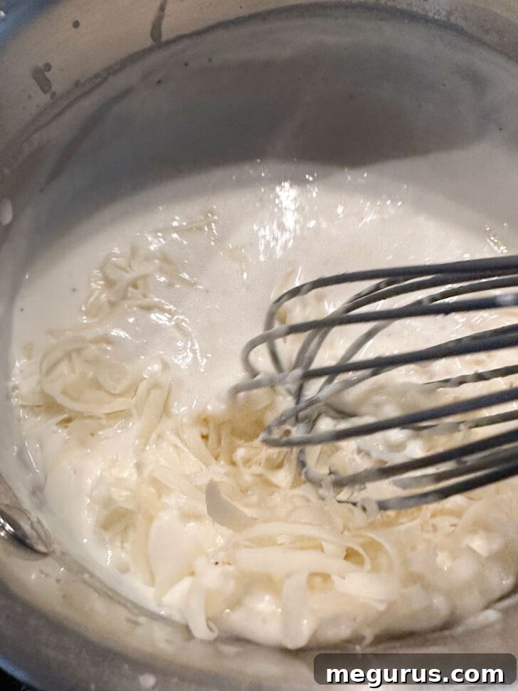 adding cheese to the finished sauce