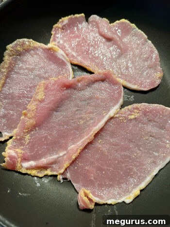 peameal bacon cooking in frying pan