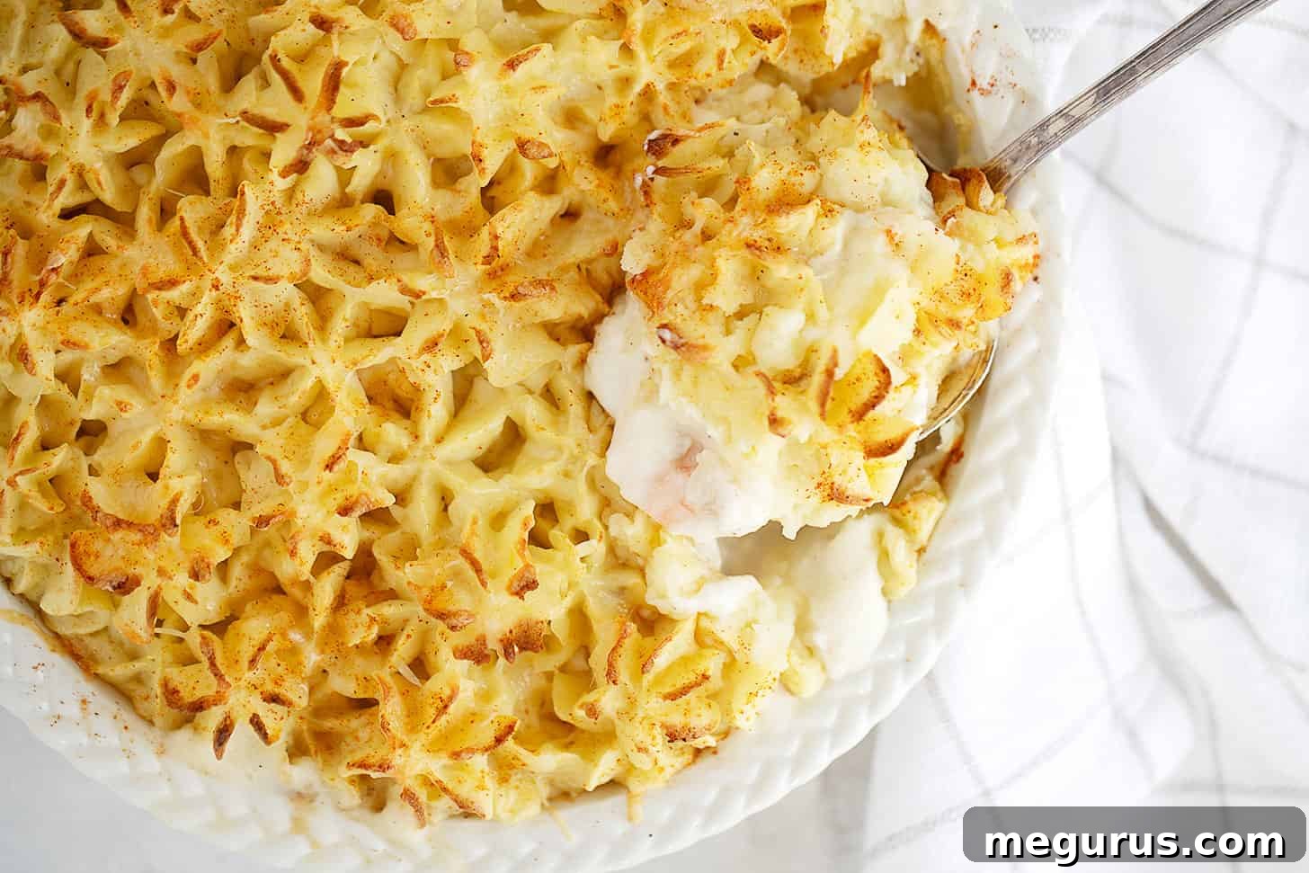 Hearty Fish Pie in a Rustic Baking Dish with a Serving Spoon, Ready to Be Enjoyed