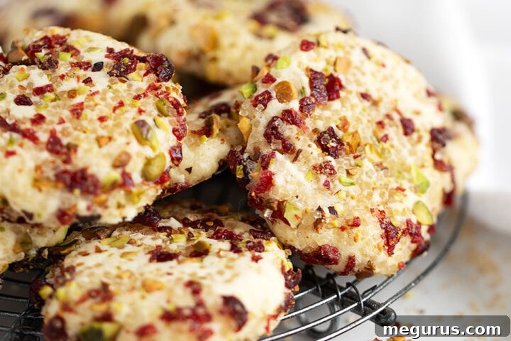 Pistachio and Cranberry Shortbread Cookies on a cooling rack, glistening with sugar.