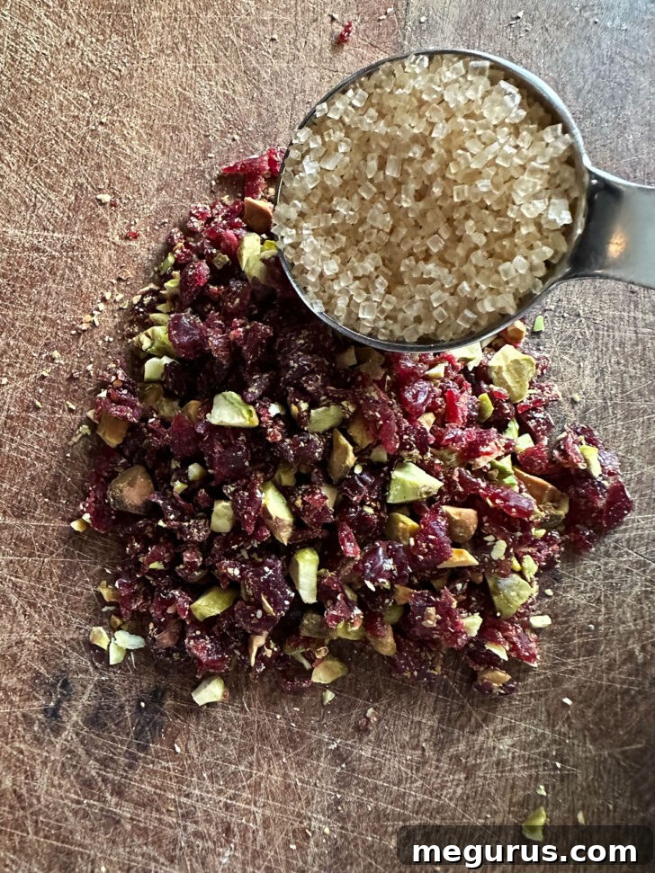 Finely chopped dried cranberries, pistachios, and turbinado sugar mixed together.