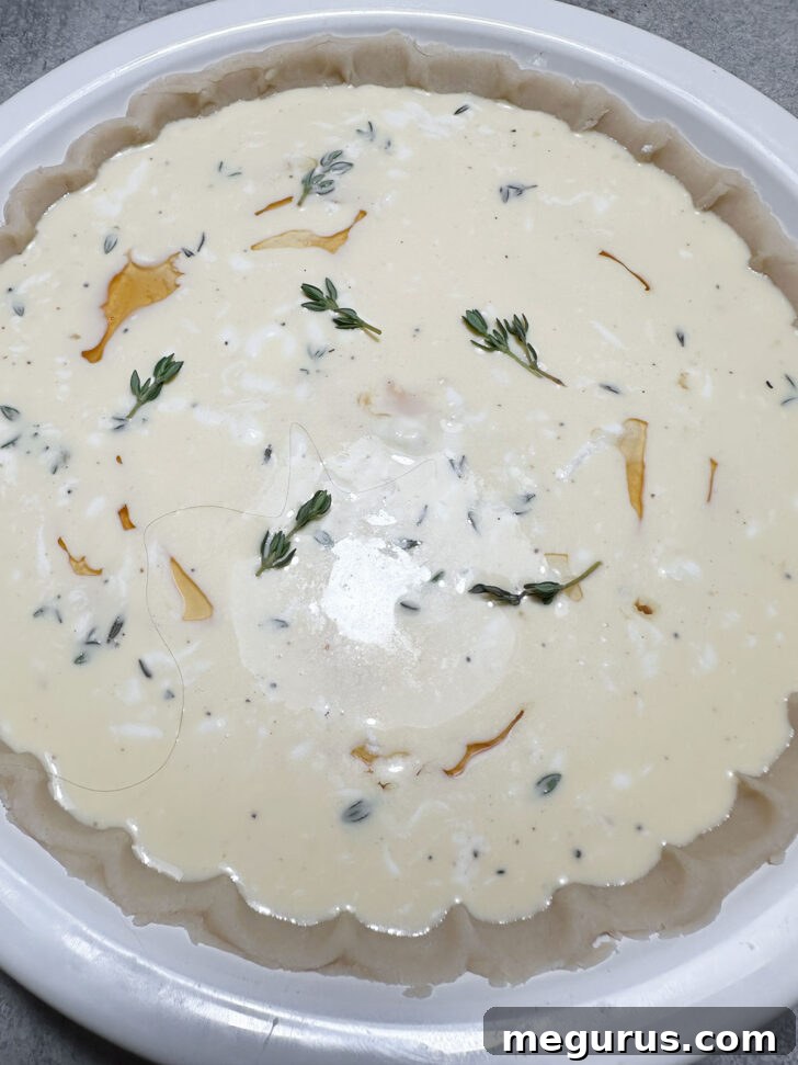 Sprinkling a few more fresh thyme leaves over the top of the quiche before it goes into the oven.