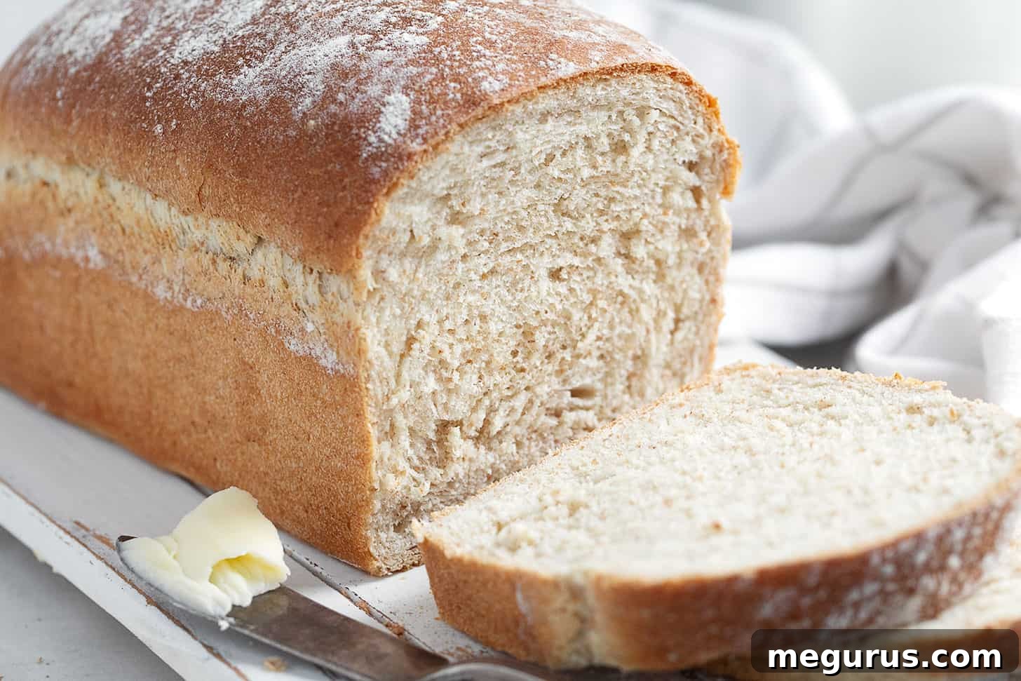 Freshly sliced honey whole wheat bread on a cutting board, ready to be served.