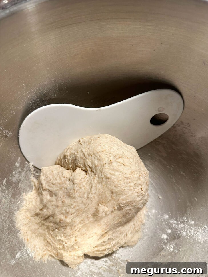 A bowl with finished dough, showing a silicone scraper used to remove it easily.