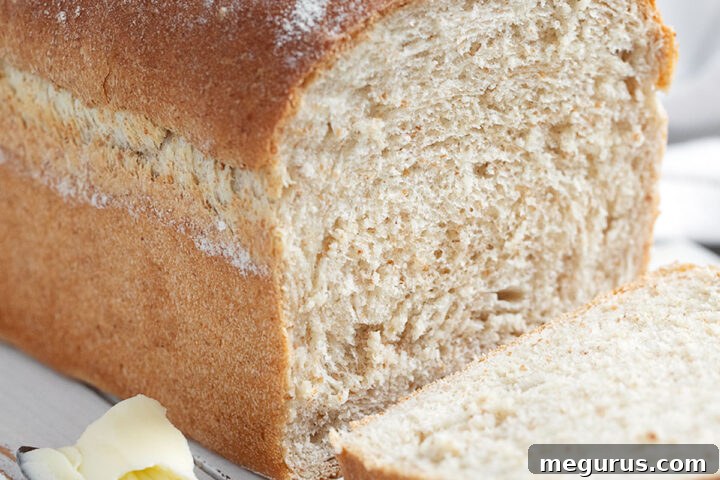 honey whole wheat bread sliced on cutting board
