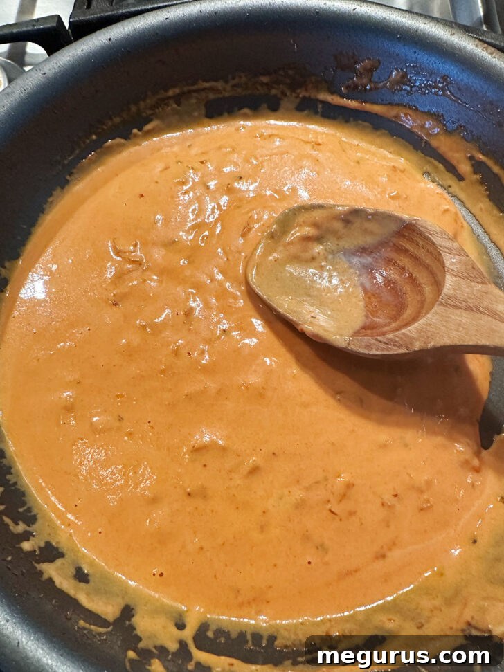 The perfectly emulsified creamy vodka tomato sauce in the skillet.