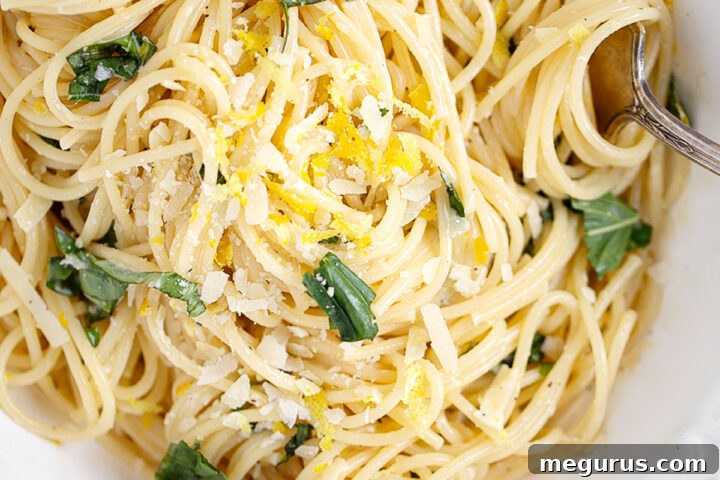 Creamy lemon pasta in a white bowl, ready to serve.