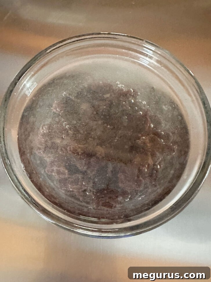 Raisins soaking in hot water to plump them.
