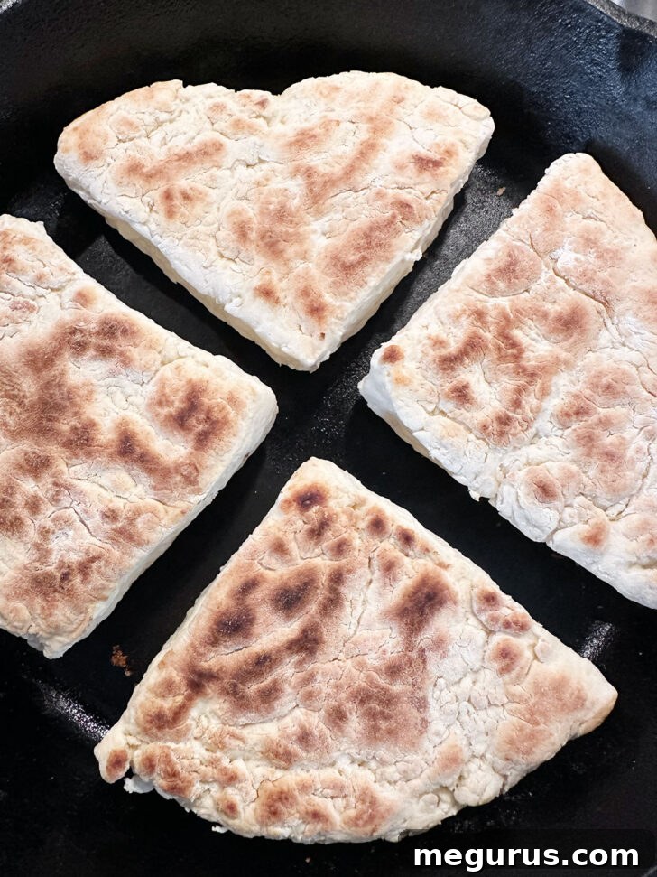 Soda farls after flipping in the skillet.
